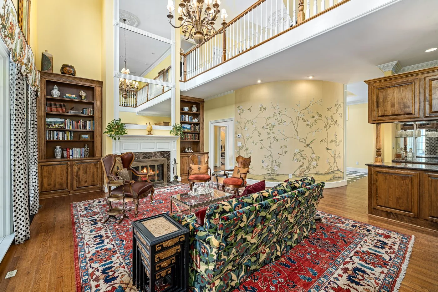 Luxurious living room featuring vintage furniture, ornate rugs, and a grand fireplace.