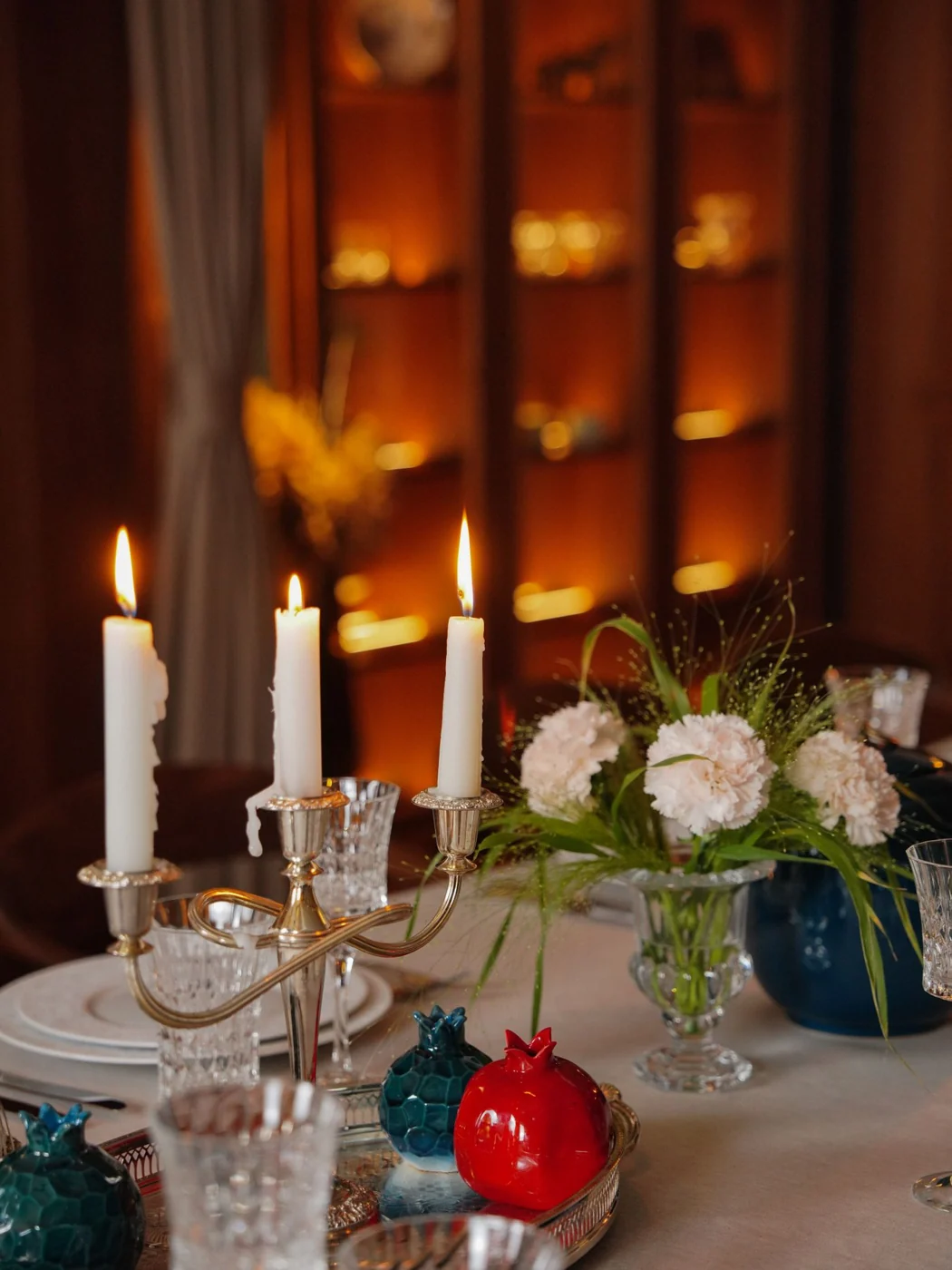 A beautifully set table with flowers and candles for a romantic dinner setting.