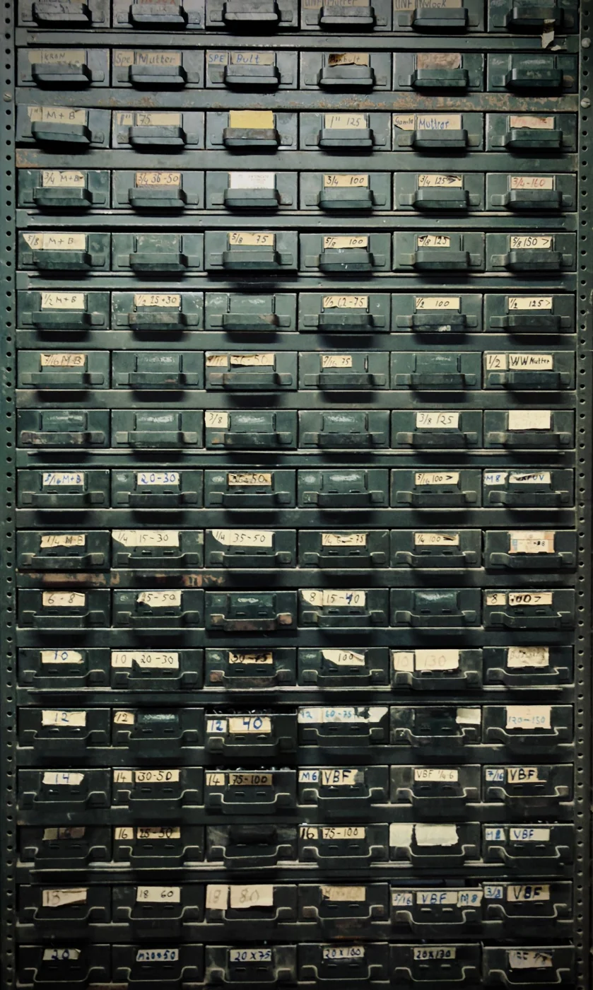 A vintage metal cabinet with labeled drawers, ideal for industrial-themed decor.