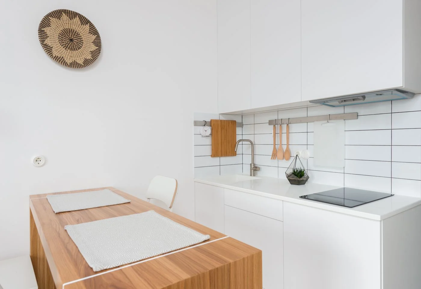 A bright, modern minimalist kitchen interior with wooden accents and clean lines.