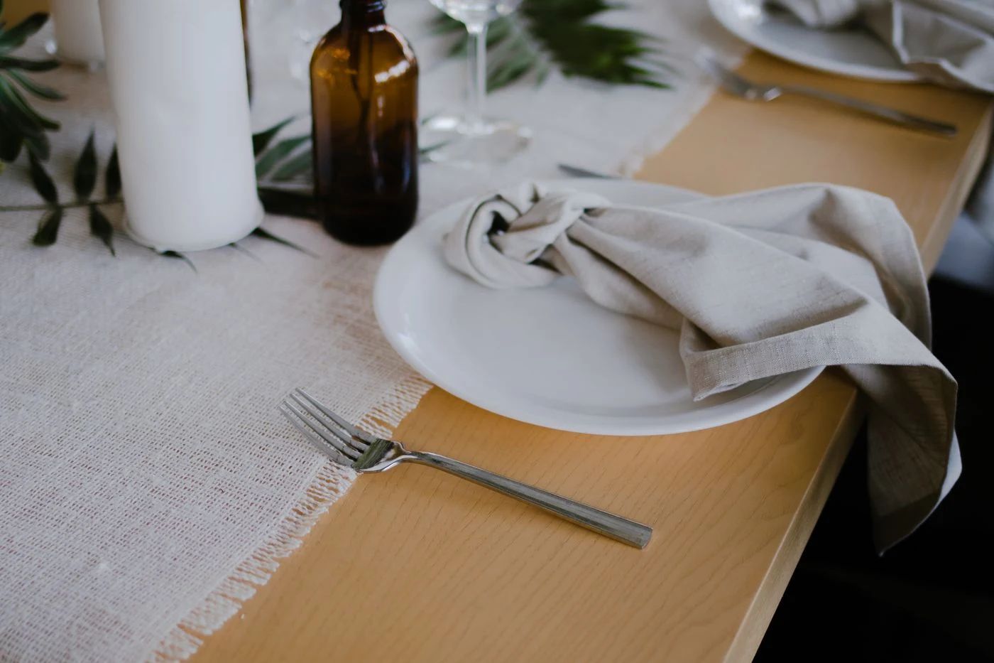 A place setting with a linen napkin and simple table decorations.